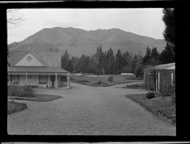 Hanmer Springs bath house and grounds, with trees and mountain in background, Canterbury Region