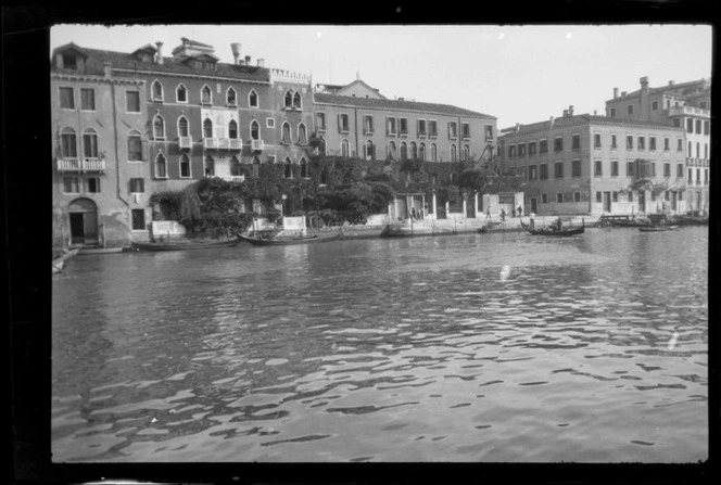 Hotel Casa Petrarca covered in vine beside the Grand Canal, with gondolas moored alongside, Venice, Italy