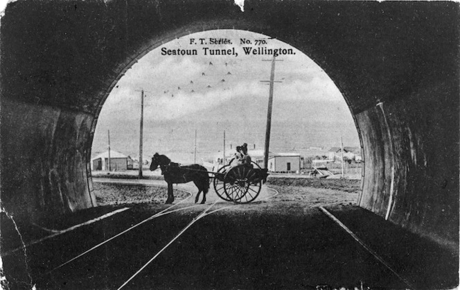 Looking from inside the Seatoun Tunnel towards a horse drawn cart, and the sea