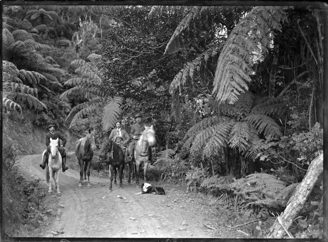 Three men on horseback on the Karekare Road.