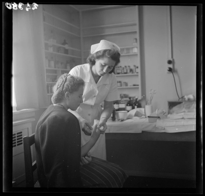 A woman has her finger bandaged at a Polish refugee camp, Pahiatua