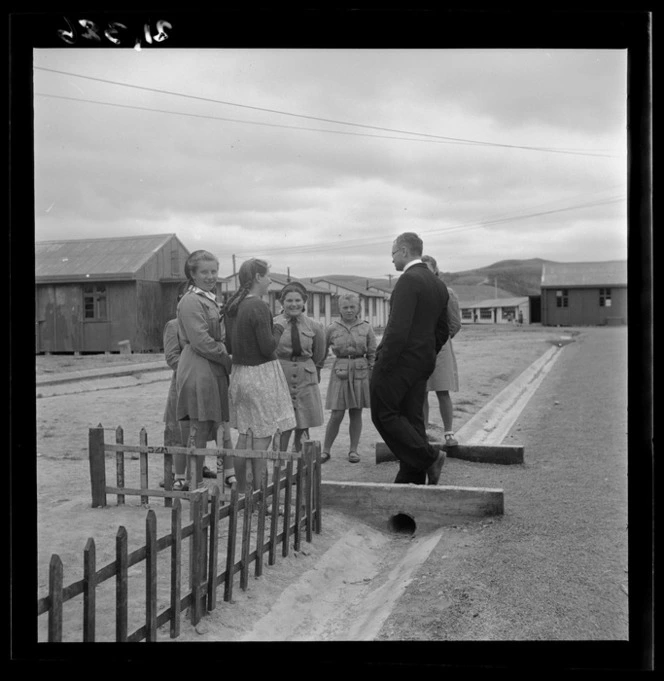 Father Wilniewczyc talks to a group of girls at a Polish refugee camp, Pahiatua