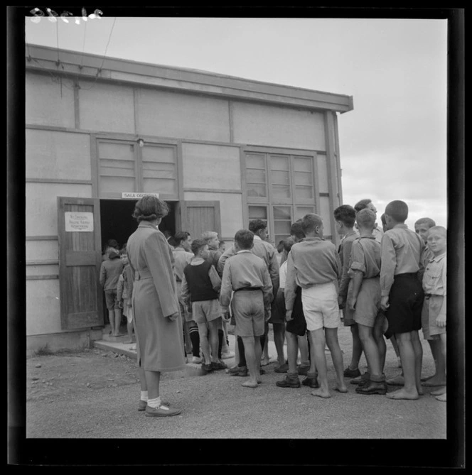 A queue of boys outside the auditorium (sala odczytowa) at a Polish refugee camp, Pahiatua