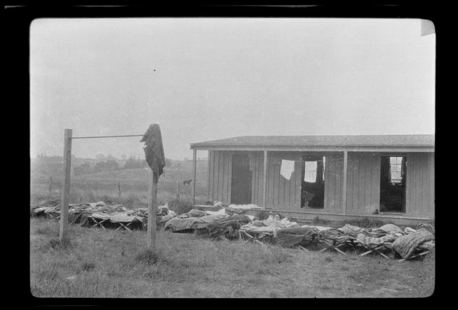 Camp beds outside a sleeping hut at the New Zealand Flying School at Kohimarama, Auckland