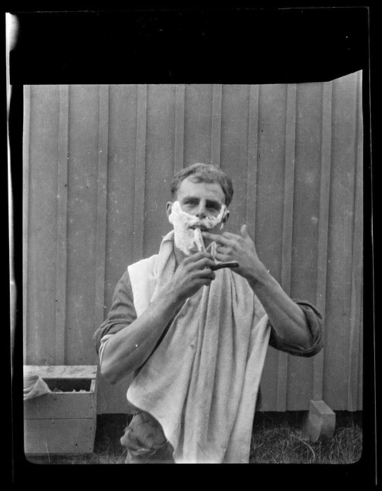 Student pilot Frank Lethbridge shaving at the New Zealand Flying School, Kohimarama, Auckland