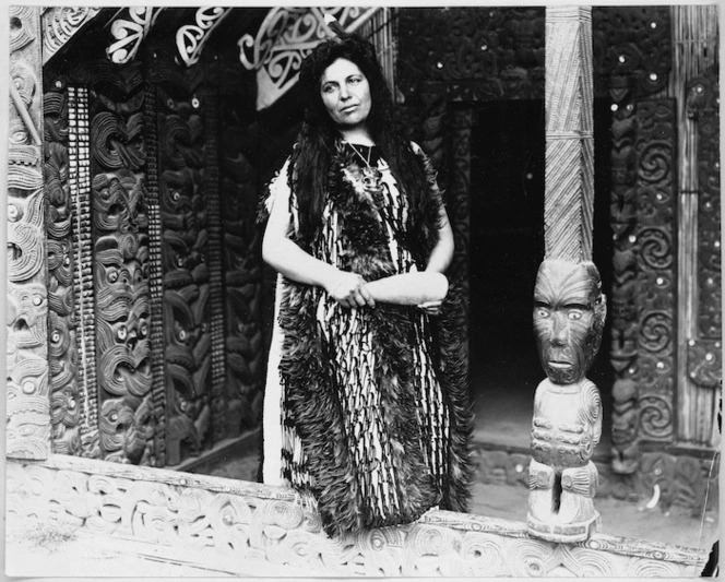 Photograph of Maggie Papakura in front of a meeting house