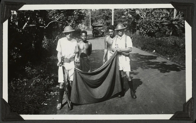 Sailors removing the white band, the insignia of the Mau, from lava lavas