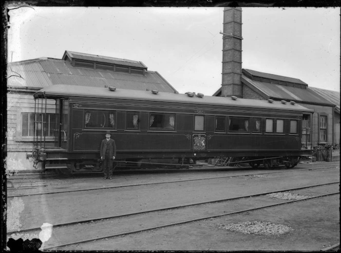 Exterior view of the royal train carriage, used during the Duke of Cornwall & York's 1901 visit. Albert Percy Godber standing in front.