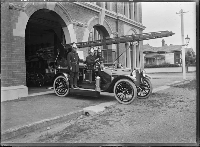 Firemen and a fire engine outside Petone Fire Station