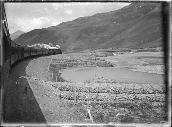 Otira to Christchurch Express train on a bend alongside the Waimakariri River.