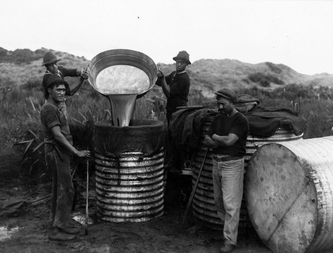 Unidentified Maori group pouring whale oil