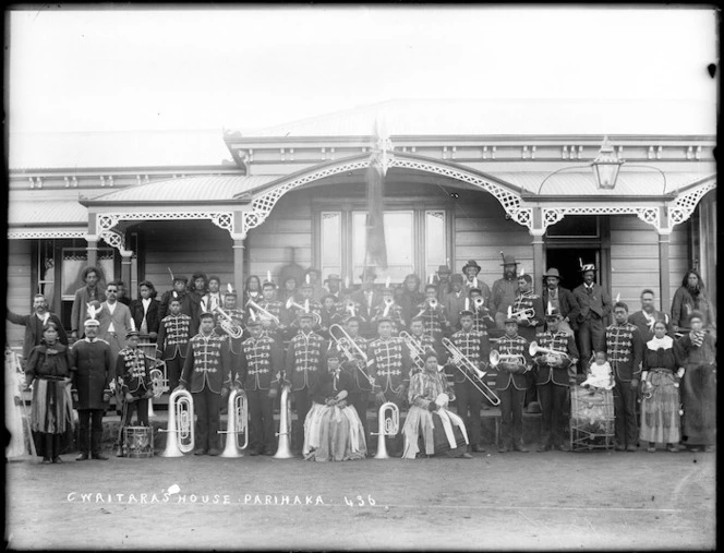 Members of a brass band, and others, outside the house of Charles Waitara, at Parihaka