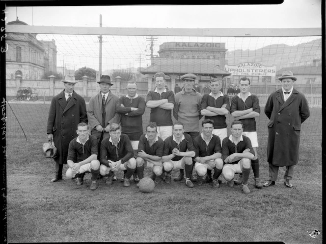 Porirua Hospital Association Football Club soccer team on Basin Reserve, with Kalazoic Upholsterers building in the background