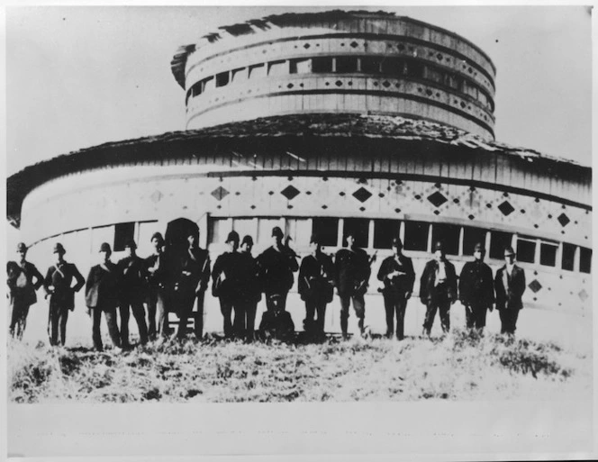 Police alongside Rua Kenana Hepetipa's wooden circular courthouse and meeting house at Maungapohatu