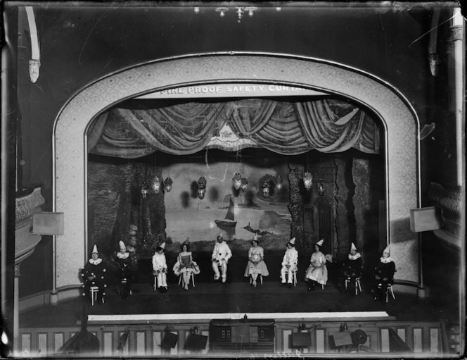 Theatre stage with members of Fuller's Vaudeville as pierrots and pierrettes