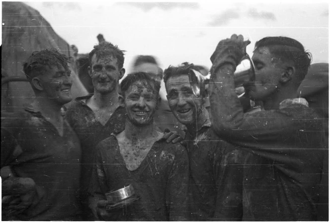 Kaye, George, 1914- : 22 NZ Bn team drink from the Freyberg Cup after the final game of the Freyberg Cup, Forli, Italy