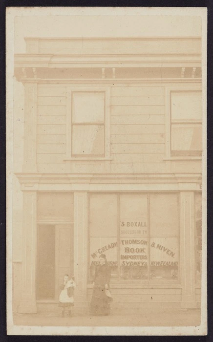 Photographer unknown :Portrait of woman and child in front of the business premises of S Boxall
