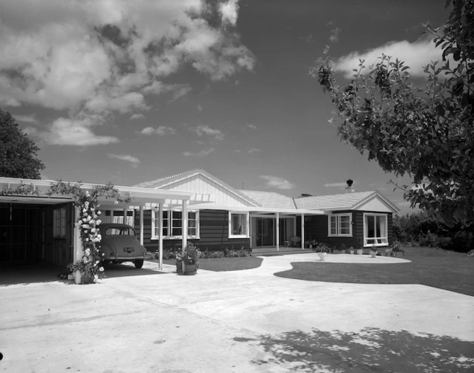 House, carport and Morris Minor