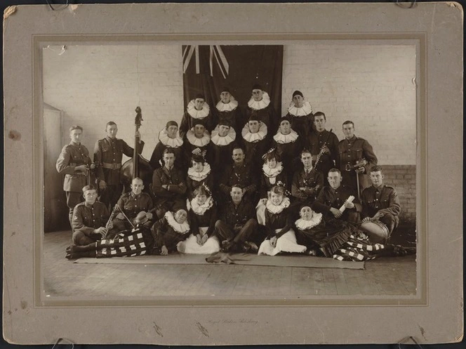 Group portrait of theatre performers in costume and military orchestra