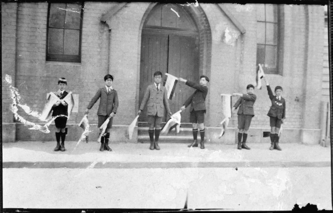 Chinese boys in Wellington with semaphore flags that spell 'China'