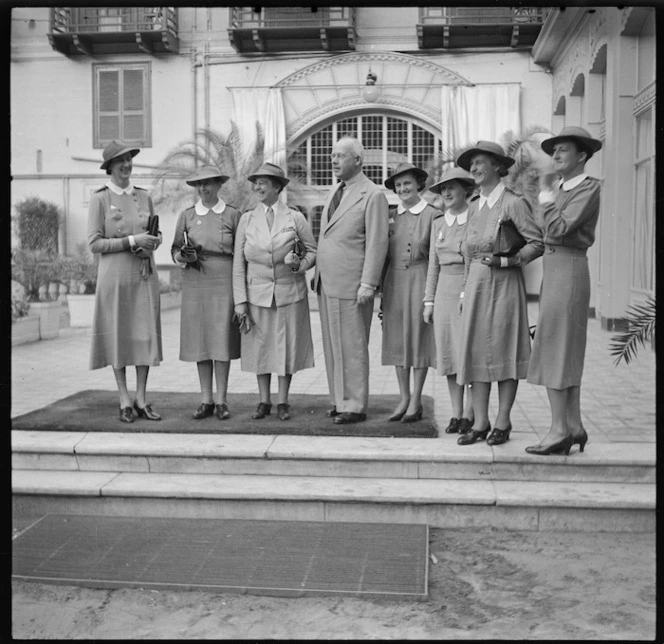 Prime Minister Peter Fraser with Emily May Nutsey and other nurses at Shepheards Hotel in Cairo, Egypt