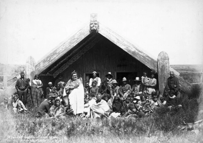 Maori group outside a meeting house at Waipahihi, includes Rangitahau and Kiriwera