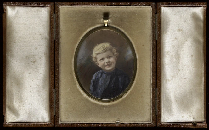 Photograph of Douglas Lilburn as a child, inside a locket and case