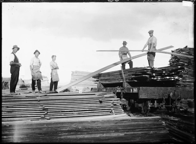 Loading timber onto a railway bogie in a sawmill yard