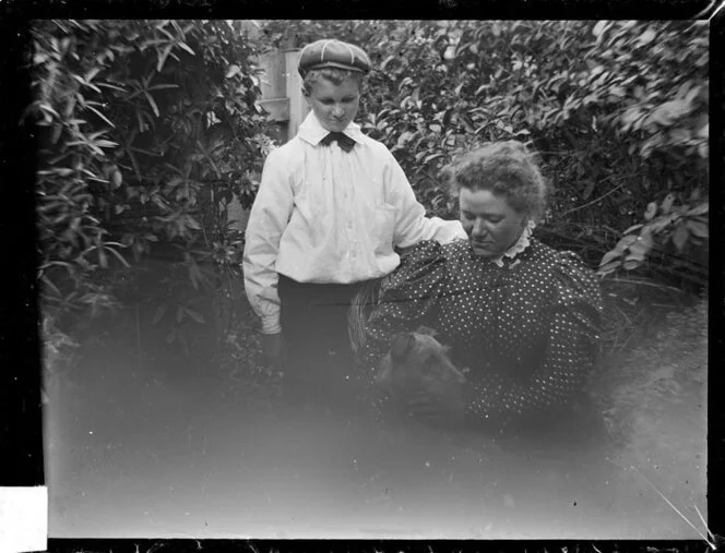 Amy Kirk and a boy in garden with a dog