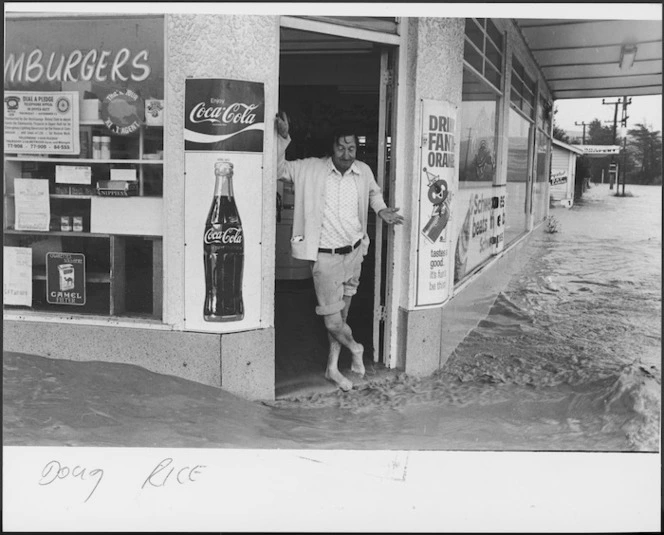 Floodwaters passing a dairy, Silverstream, Upper Hutt - Photograph taken by Ray Pigney