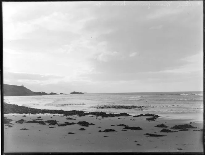 View of surf at Ocean Beach, Mount Maunganui, with Karewa Island in the distance