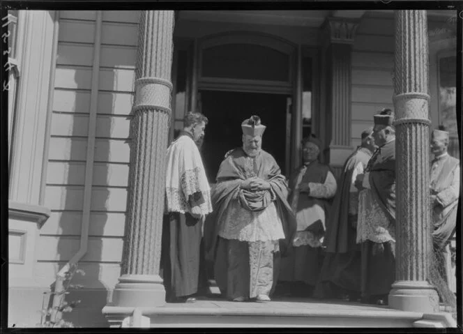 Archbishop Redwood leaving building with entourage