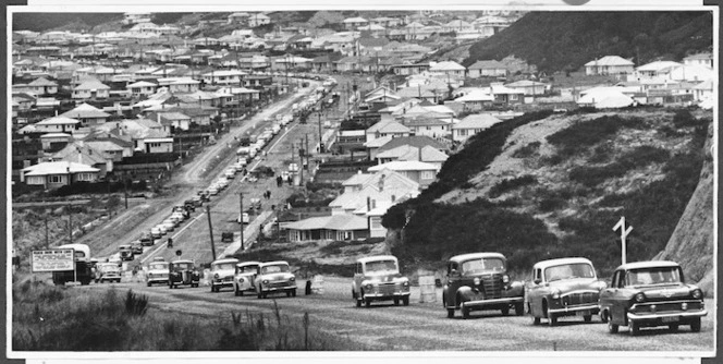 Queue of cars driving on newly sealed road, Wainuiomata