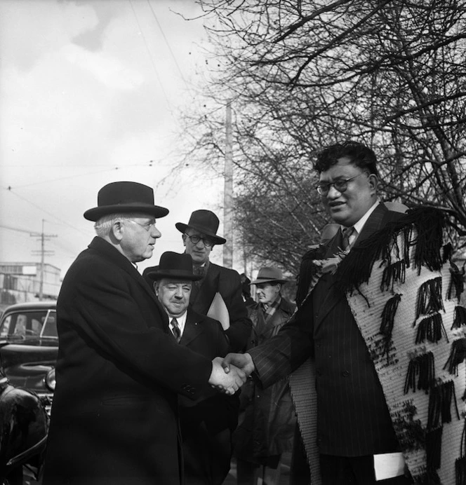 Prime Minister Peter Fraser being welcomed to the opening ceremony of the Maori Community Centre in Auckland by Tapihana Paraire Paikea the Member of Parliament for Northern Maori