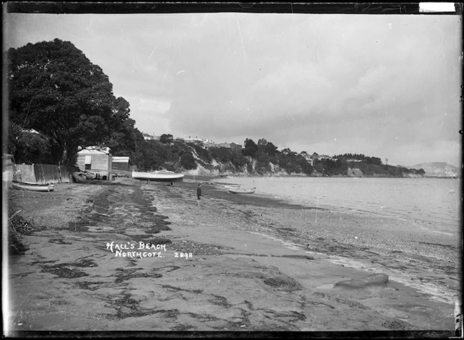 Boats and boy at Hall's Beach, Northcote, Auckland