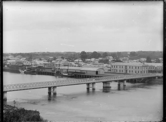 Victoria Avenue bridge over the Whanganui River looking to the town with two steamers at the railway wharf