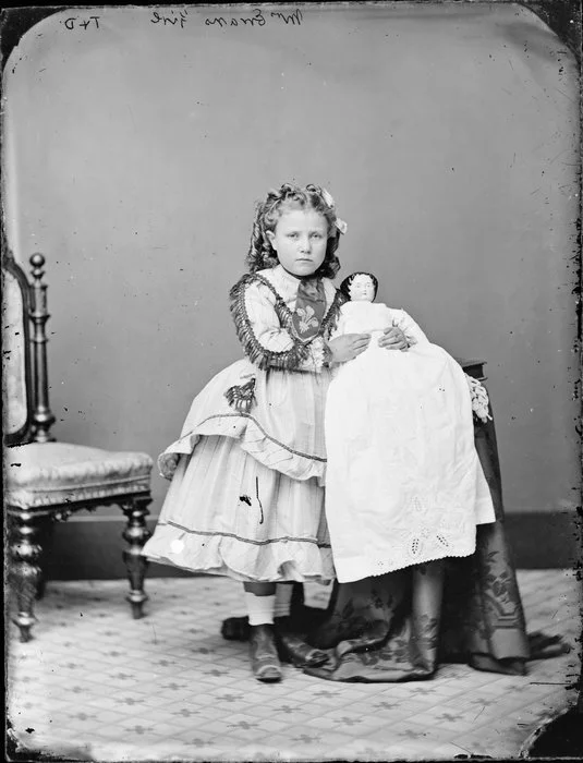 Girl from Evan family, aged 6 holding a doll - Photograph taken by Thompson & Daley of Wanganui