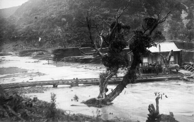 Piha Creek in flood showing a timber yard