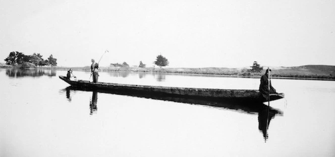 The last of the old Maori war-canoes on Lake Horowhenua. Members of the Taueki family spearing eels from the canoe "Hamaria"; length about 60ft. 9 June 1926
