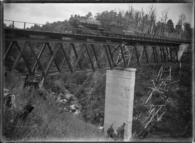 Goods train, with steam locomotive, crossing the Manganui a te Ao Viaduct.