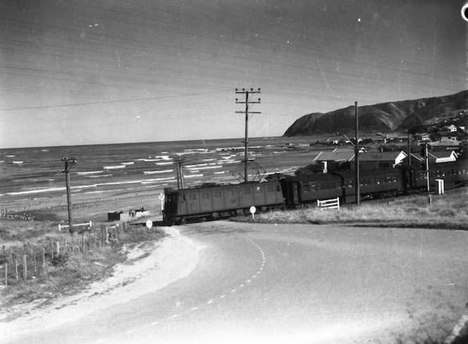 A passenger train passing through a railway crossing at Plimmerton