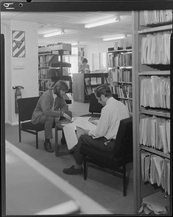 Sumpters, men looking over papers