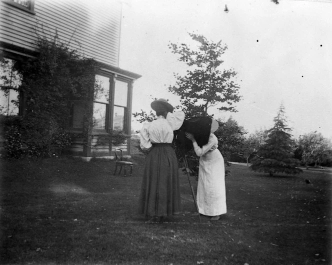 Fanny Mason, with a camera set up in a garden