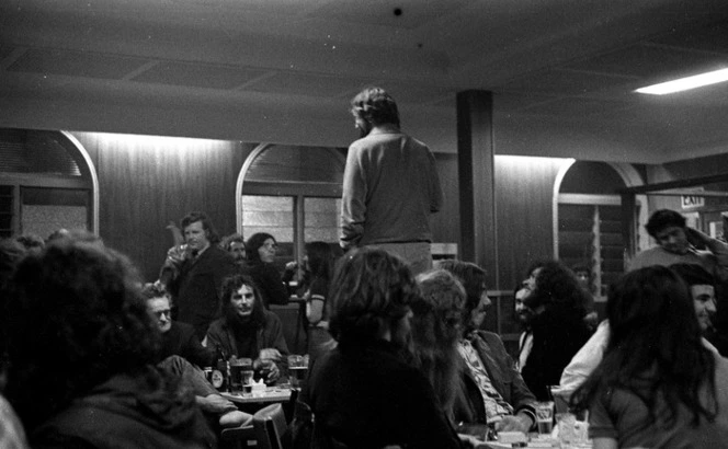 Kiwi pub chap standing on chair