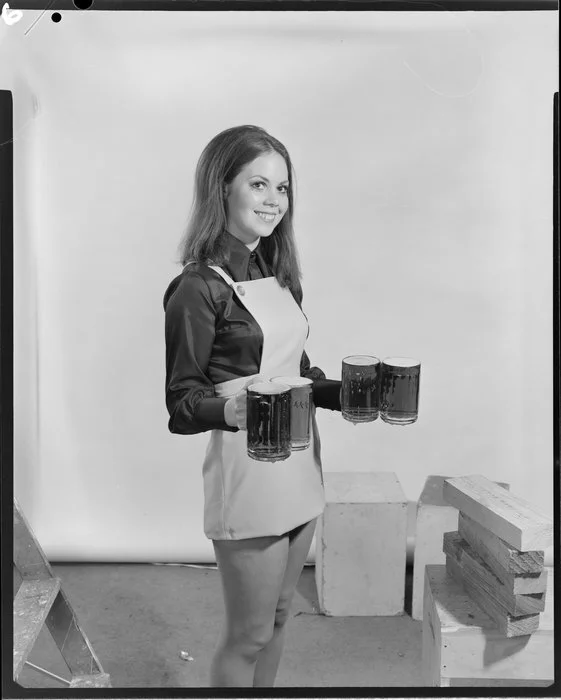 Woman carrying four beer steins