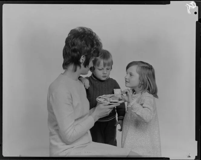 Woman and two children with crackers on a plate