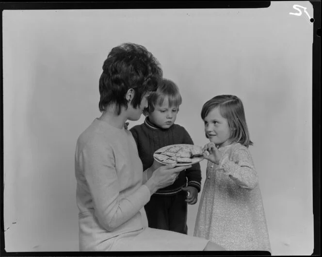 Woman and two children with crackers on a plate