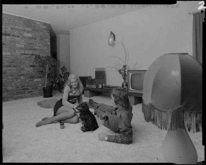 Young people with dog in lounge