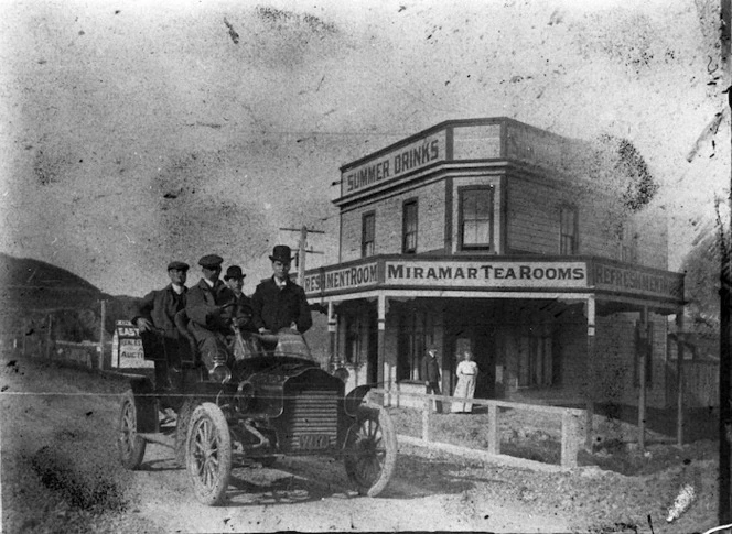 Group in a car, alongside the Miramar Tea Rooms