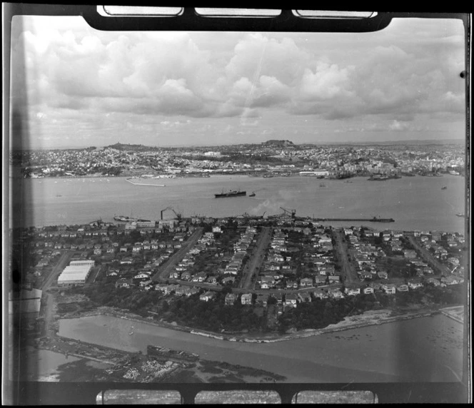 Stanley Point residential area with Ngataringa Bay in foreground with Devon Port Naval Base Stanley Bay beyond, looking to Auckland City